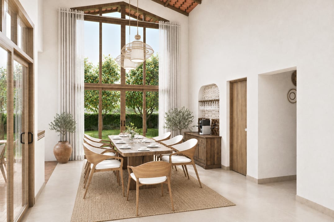 Light-filled dining room with a natural wood table, arched detailing and garden views